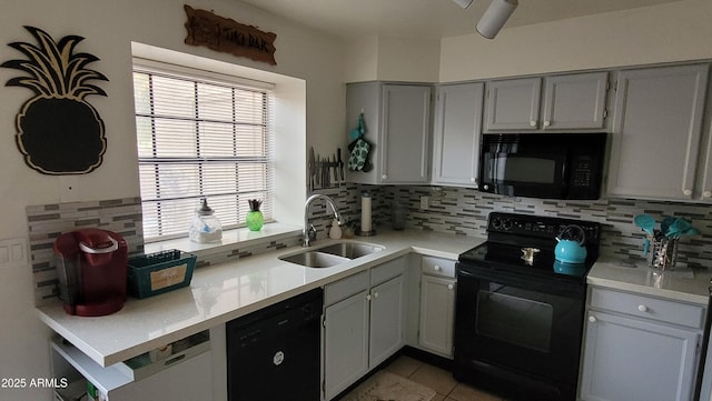 kitchen featuring sink, decorative backsplash, and black appliances