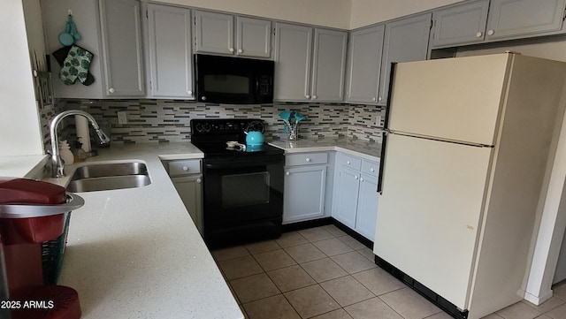 kitchen with sink, backsplash, black appliances, and light tile patterned flooring