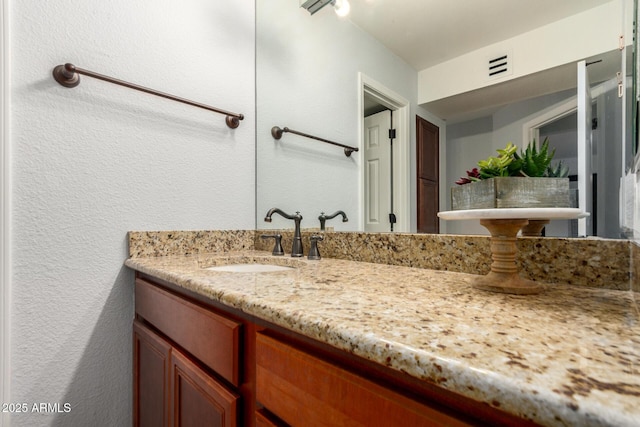 8500 E Indian School Rd Unit 233, Scottsdale, AZ 85251 - bathroom with a textured wall and vanity