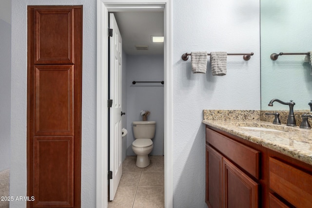 8500 E Indian School Rd Unit 233, Scottsdale, AZ 85251 - bathroom with tile patterned flooring, toilet, vanity, and a textured wall