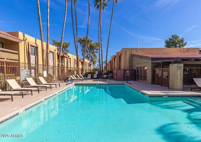8500 E Indian School Rd Unit 233, Scottsdale, AZ 85251 - community pool with fence, a patio area, and a residential view