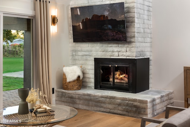 details featuring wood-type flooring and a brick fireplace