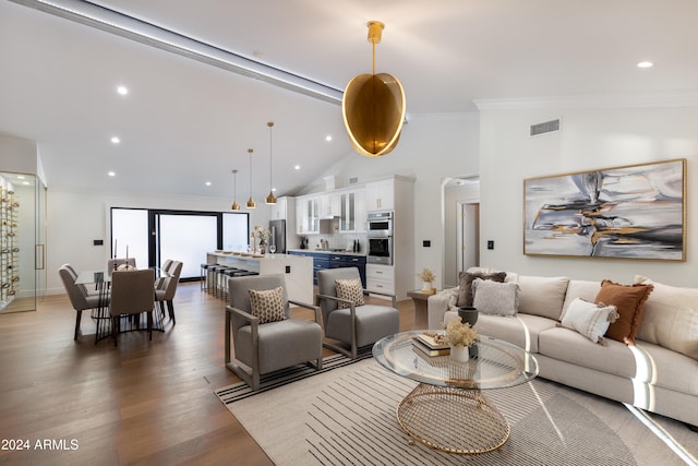 living room featuring high vaulted ceiling, ornamental molding, and hardwood / wood-style flooring