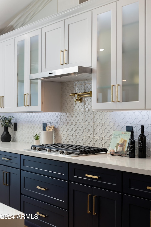 kitchen featuring white cabinetry, crown molding, and stainless steel gas cooktop