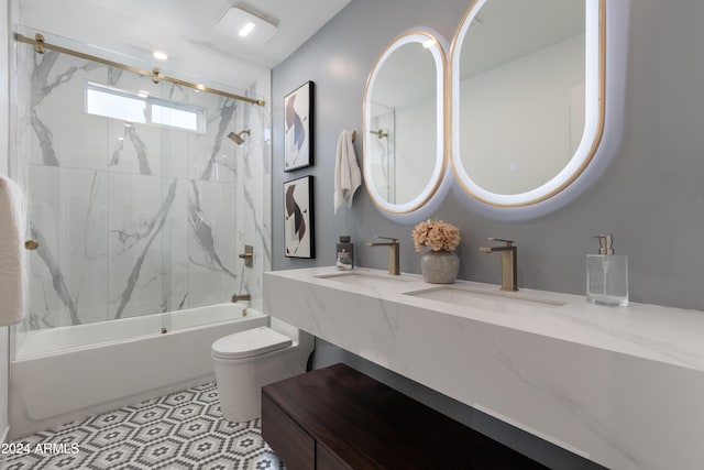 full bathroom featuring toilet, vanity, and tiled shower / bath