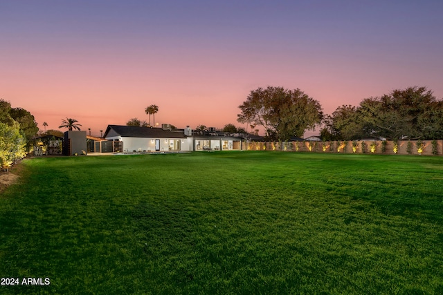 view of yard at dusk