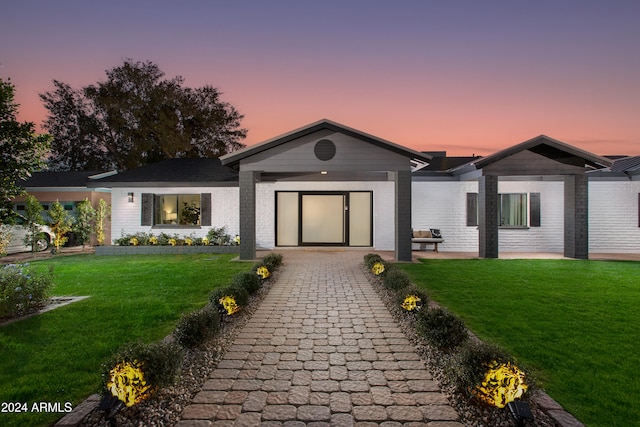 ranch-style house featuring a lawn