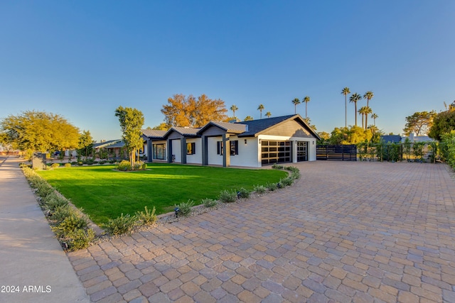 ranch-style house with a front yard and a garage