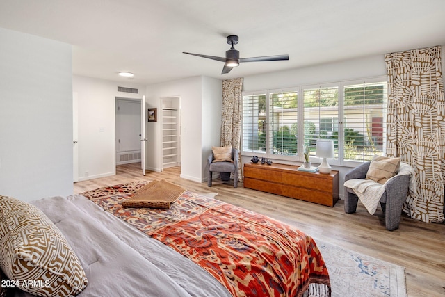 bedroom featuring visible vents, baseboards, and wood finished floors