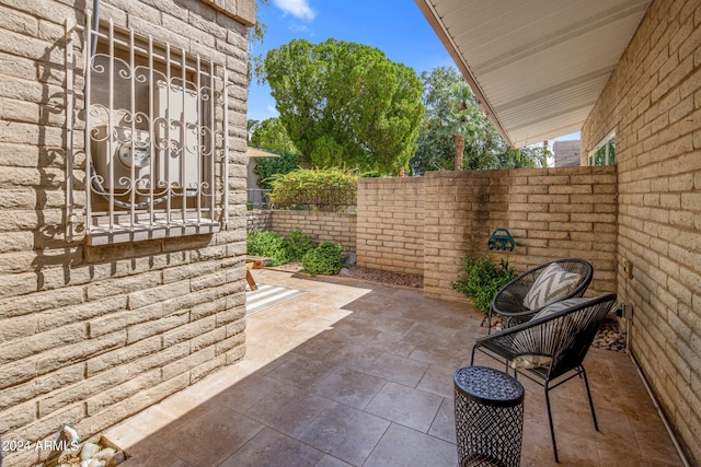 view of patio featuring fence