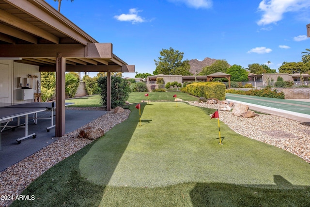 view of yard featuring shuffleboard, a patio area, and fence