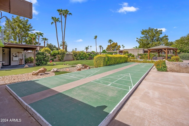 surrounding community featuring a yard, fence, a gazebo, and shuffleboard