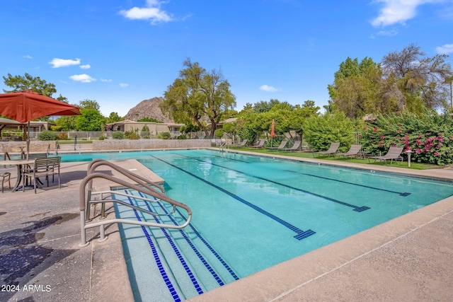 pool with fence and a patio