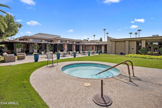 view of pool with a lawn, a hot tub, and a patio