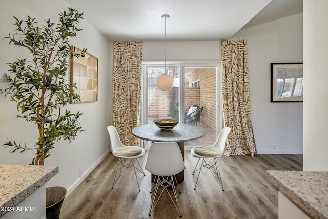 dining room with baseboards and wood finished floors