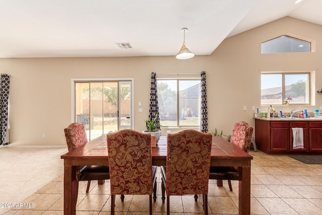 tiled dining area with lofted ceiling