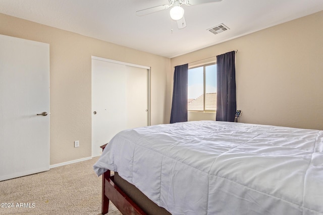 bedroom featuring ceiling fan, carpet floors, and a closet