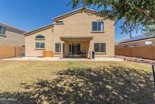 back of property featuring a yard, a patio, and central air condition unit