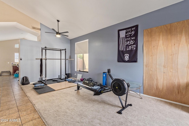 exercise area featuring a wealth of natural light, ceiling fan, light carpet, and lofted ceiling