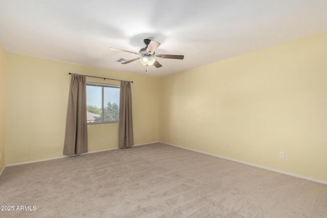 unfurnished room featuring light carpet and ceiling fan