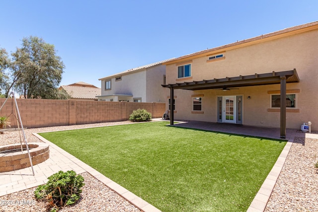 view of yard with ceiling fan, a patio area, and french doors