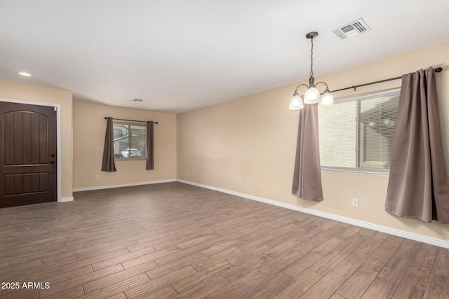 spare room featuring an inviting chandelier