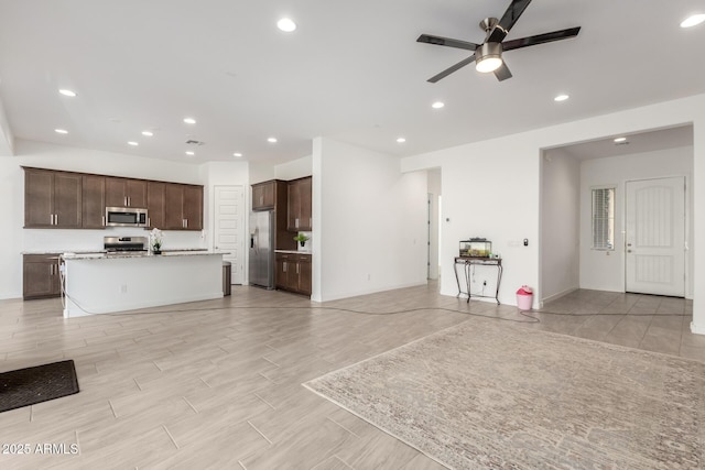 unfurnished living room with ceiling fan