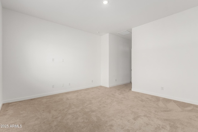 unfurnished room featuring light carpet