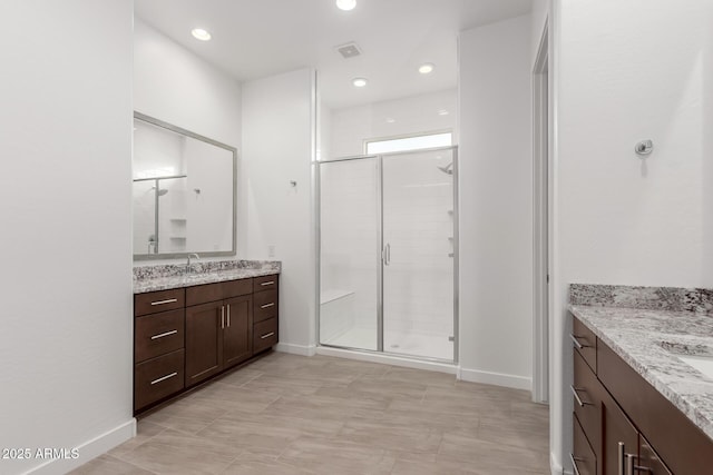 bathroom featuring vanity, an enclosed shower, and tile patterned flooring