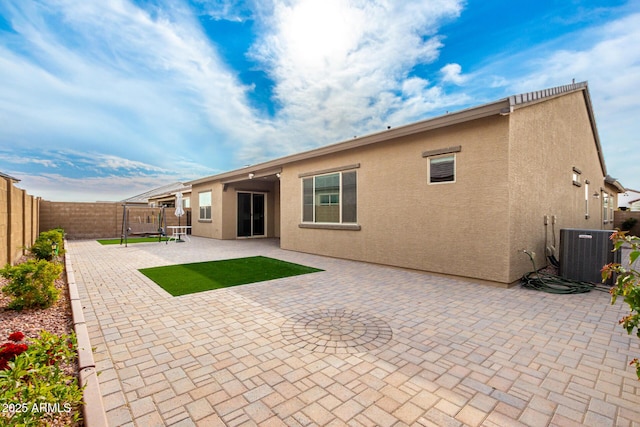 back of house featuring cooling unit and a patio area