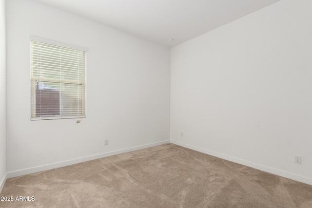 spare room featuring light colored carpet