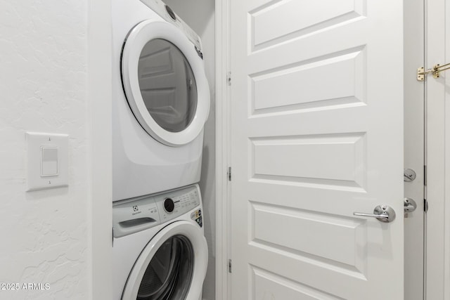 laundry room with stacked washer / dryer