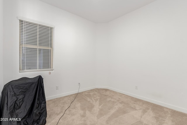 unfurnished room featuring light colored carpet