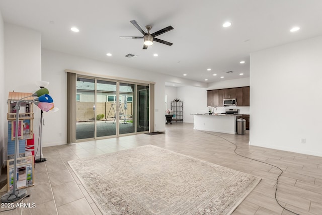 living room with sink and ceiling fan