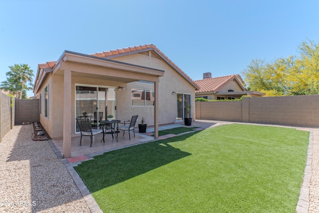 rear view of house featuring stucco siding and a patio
