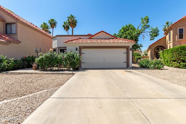 1425 E Commerce Ave, Gilbert, AZ 85234 - mediterranean / spanish-style house featuring concrete driveway, stucco siding, an attached garage, and a tiled roof