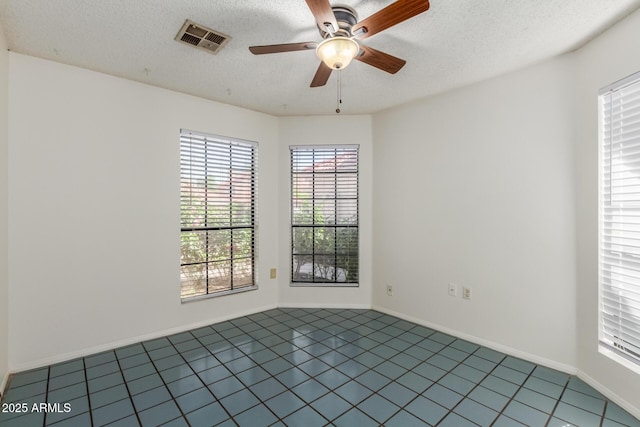 1425 E Commerce Ave, Gilbert, AZ 85234 - unfurnished room with a ceiling fan, tile patterned floors, a textured ceiling, and baseboards