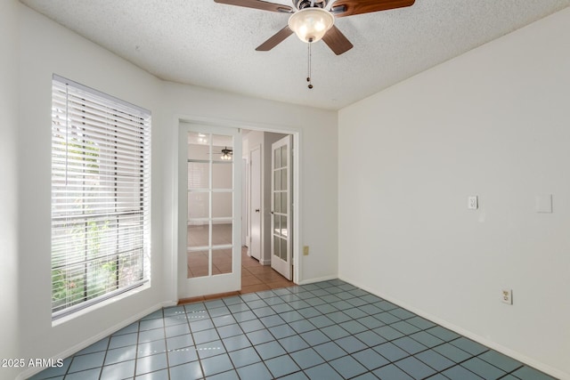 1425 E Commerce Ave, Gilbert, AZ 85234 - empty room featuring ceiling fan, a textured ceiling, baseboards, and tile patterned floors