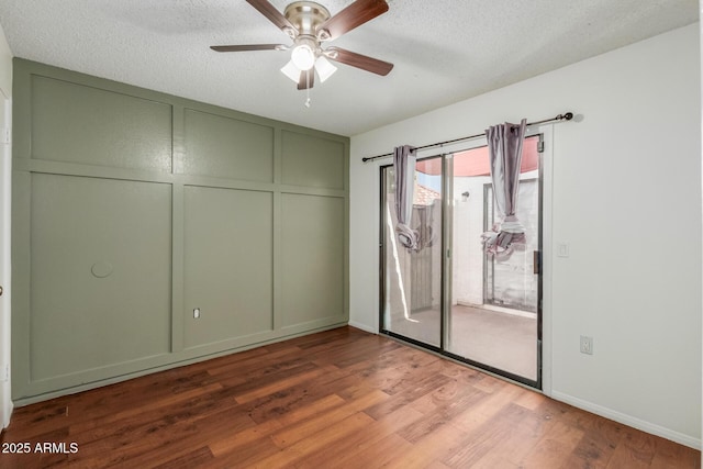 1425 E Commerce Ave, Gilbert, AZ 85234 - unfurnished bedroom featuring a decorative wall, access to exterior, wood finished floors, a closet, and a textured ceiling