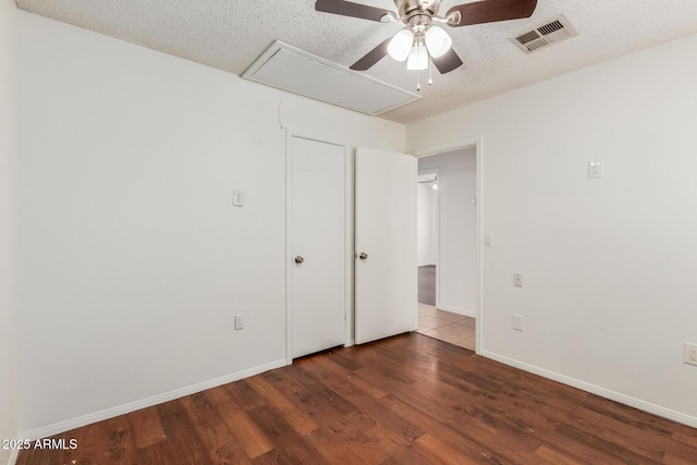 1425 E Commerce Ave, Gilbert, AZ 85234 - spare room with attic access, a ceiling fan, wood finished floors, baseboards, and a textured ceiling