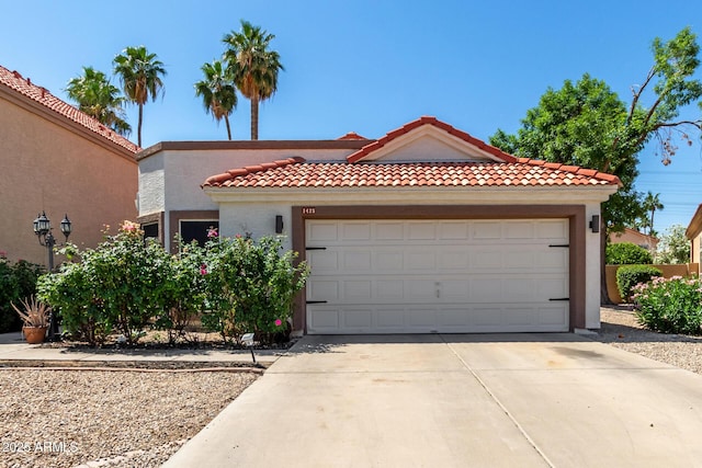 1425 E Commerce Ave, Gilbert, AZ 85234 - mediterranean / spanish-style house with a tiled roof, concrete driveway, stucco siding, and an attached garage