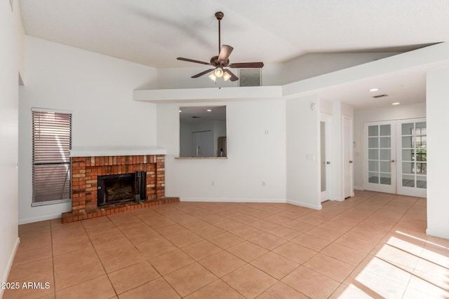 1425 E Commerce Ave, Gilbert, AZ 85234 - unfurnished living room featuring light tile patterned floors, lofted ceiling, a ceiling fan, a fireplace, and french doors