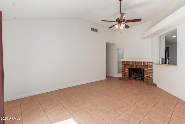1425 E Commerce Ave, Gilbert, AZ 85234 - unfurnished living room with lofted ceiling, a ceiling fan, light tile patterned floors, a fireplace, and baseboards