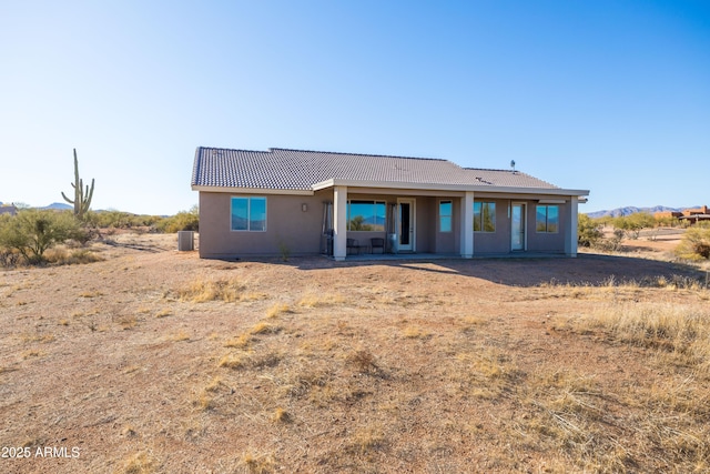 view of front of home featuring a tiled roof and stucco siding