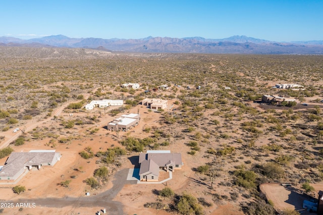 birds eye view of property featuring view of desert and a mountain view