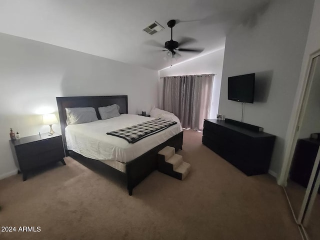 carpeted bedroom featuring ceiling fan and vaulted ceiling