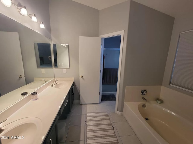 bathroom featuring tile patterned floors, a bathtub, and vanity