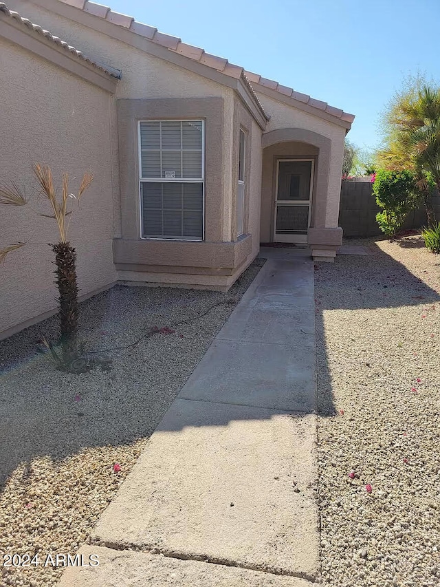 view of exterior entry featuring a patio area