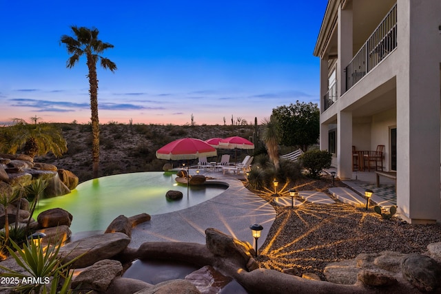 exterior space with a patio area, a jacuzzi, and a balcony