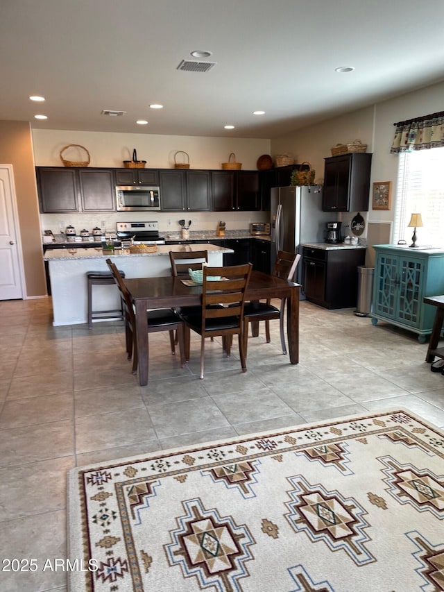 dining area featuring light tile patterned flooring